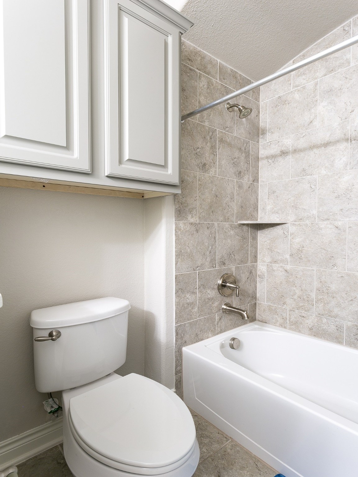 9018 Meacom Drive Conroe, TX 77384 - Photo 9 of 41 a white toilet sitting next to a bath tub and a shower