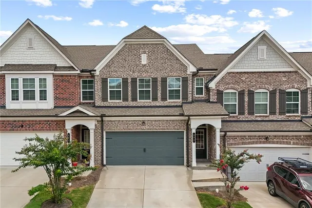 a front view of a house with a garden