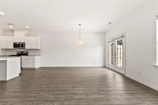 a view of kitchen with granite countertop cabinets and wooden floor