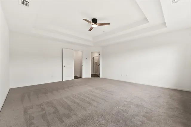 a view of an empty room with a ceiling fan