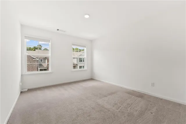 an empty room with windows and entrance