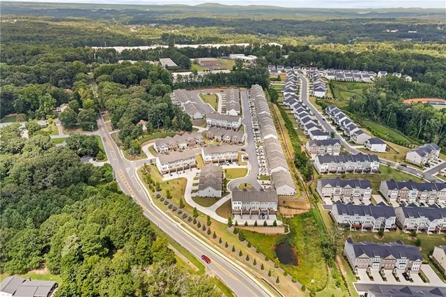 an aerial view of residential building and lake
