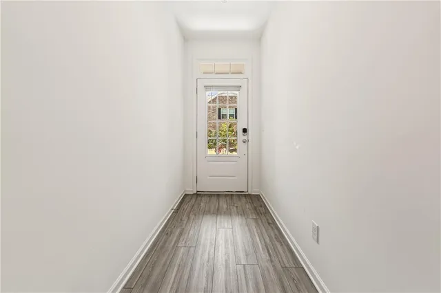 a view of a hallway with wooden floor