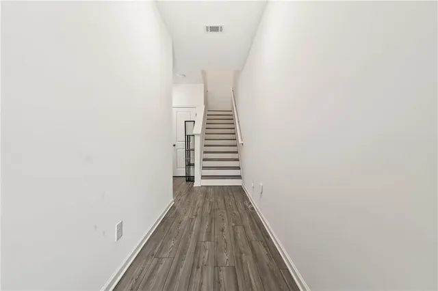 a view of a hallway with wooden floor