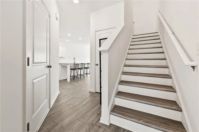 a view of entryway and hall with wooden floor