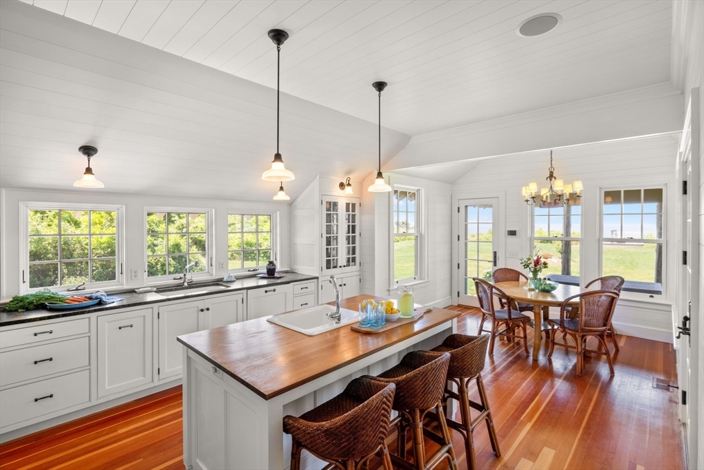 37 North Neck Road Edgartown, MA 02539 - Photo 13 of 40 a view of a dining room and livingroom with furniture wooden floor a chandelier