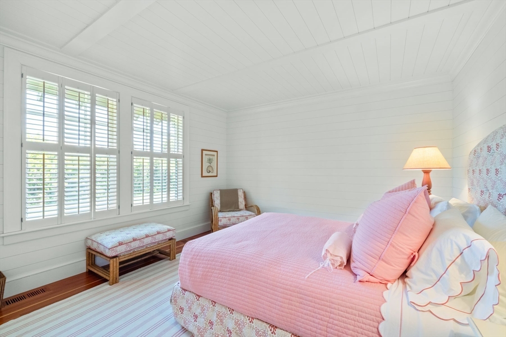 37 North Neck Road Edgartown, MA 02539 - Photo 21 of 40 a bedroom with a bed and wooden floor