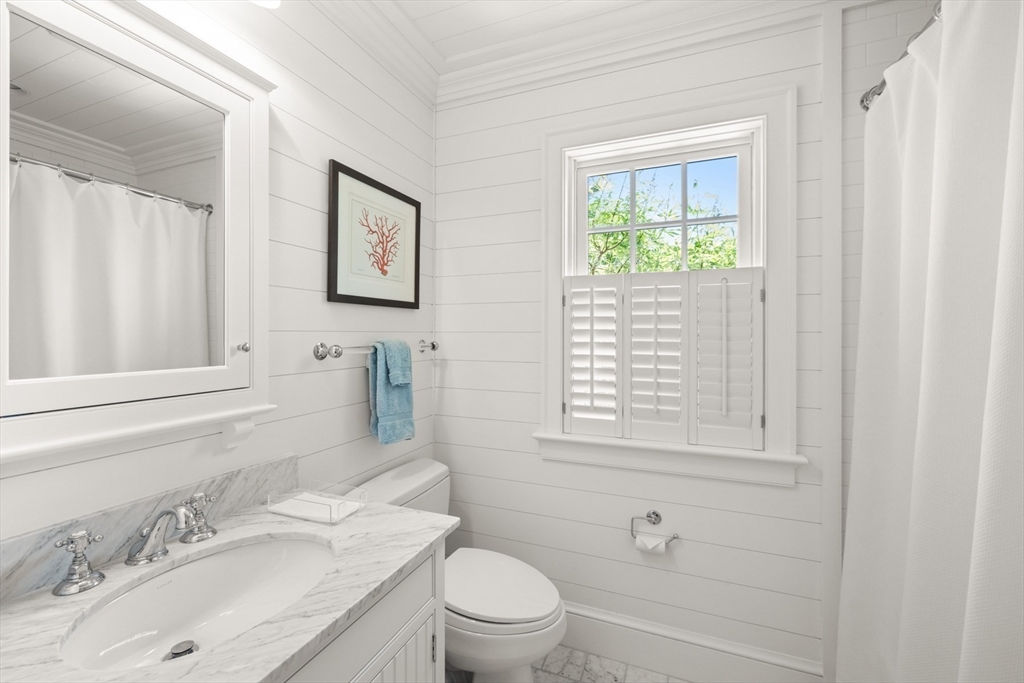 37 North Neck Road Edgartown, MA 02539 - Photo 30 of 40 a bathroom with a granite countertop sink toilet a large mirror and shower
