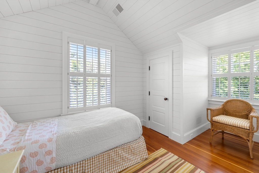 37 North Neck Road Edgartown, MA 02539 - Photo 31 of 40 a bedroom with a bed and a chair