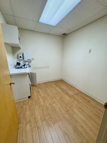 a room with a wooden floor and cabinets
