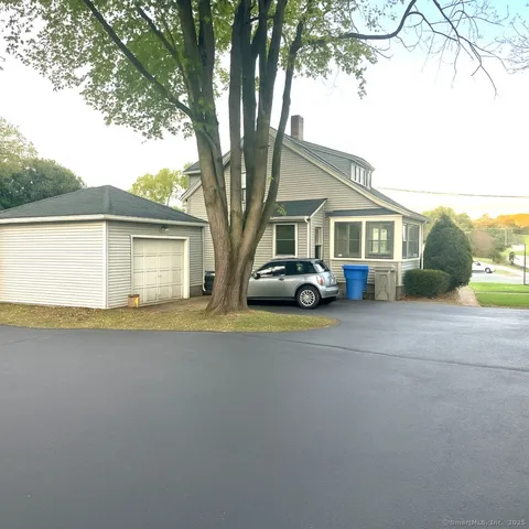 a car parked in front of white house