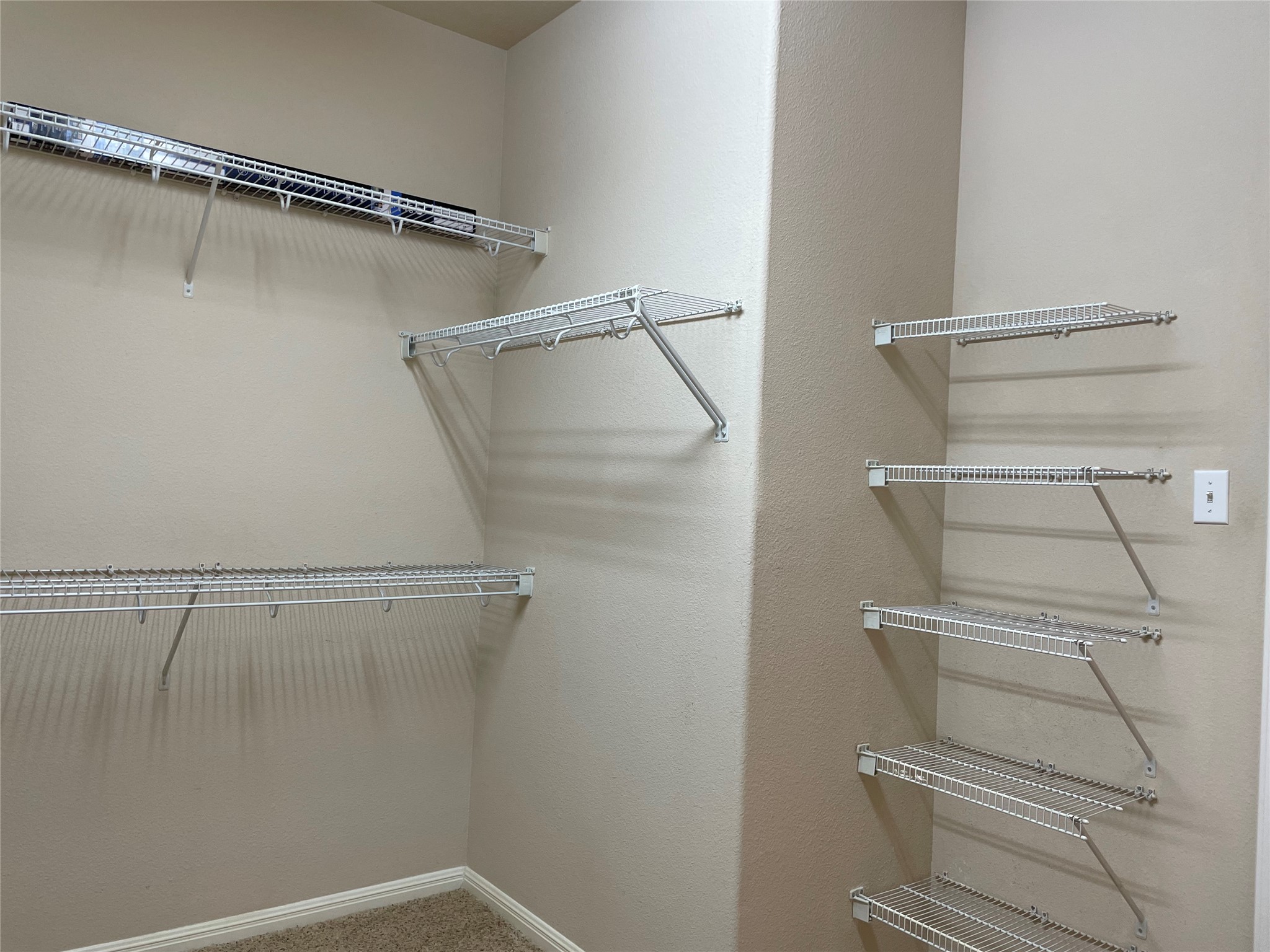 11713 Dunblane Way Austin, TX 78754 - Photo 15 of 22 Walk-in closet featuring extensive wire shelving, multiple hanging rods, and neutral wall tones