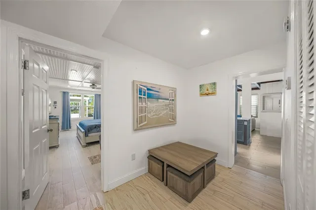 a living room with a bed and ceiling fan