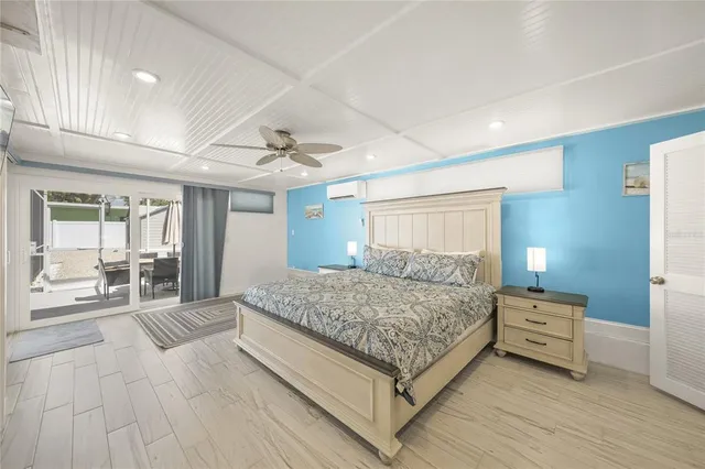 a spacious bedroom with a large bed and a flat screen tv