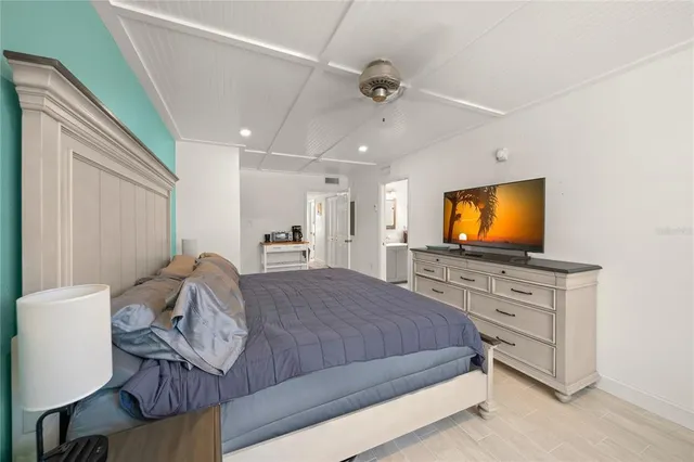 a bedroom with a large bed and a window