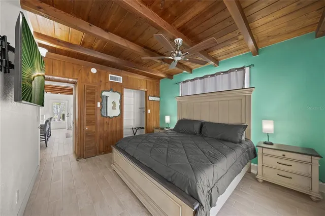 a view of a big room with wooden floor and furniture