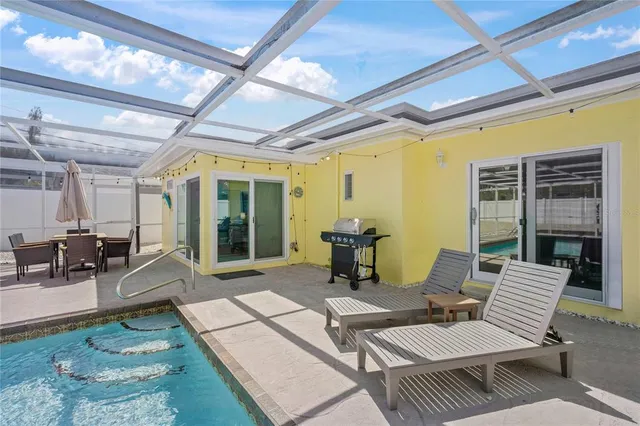 a view of a lake with a floor to ceiling window and wooden fence
