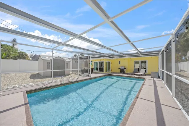a view of a house with swimming pool and sitting area