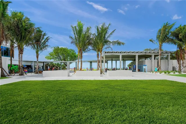 an outdoor space with lots of tables and chairs