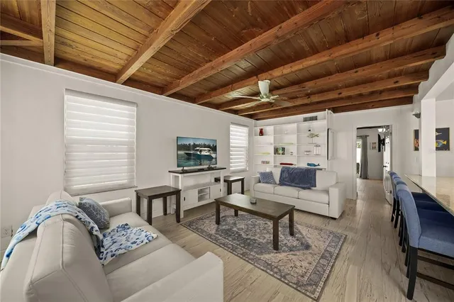 a dining room with furniture a rug and wooden floor