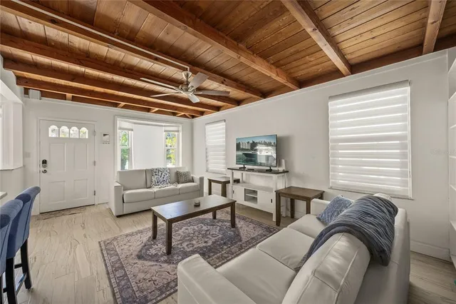 a dining room with furniture a chandelier and wooden floor