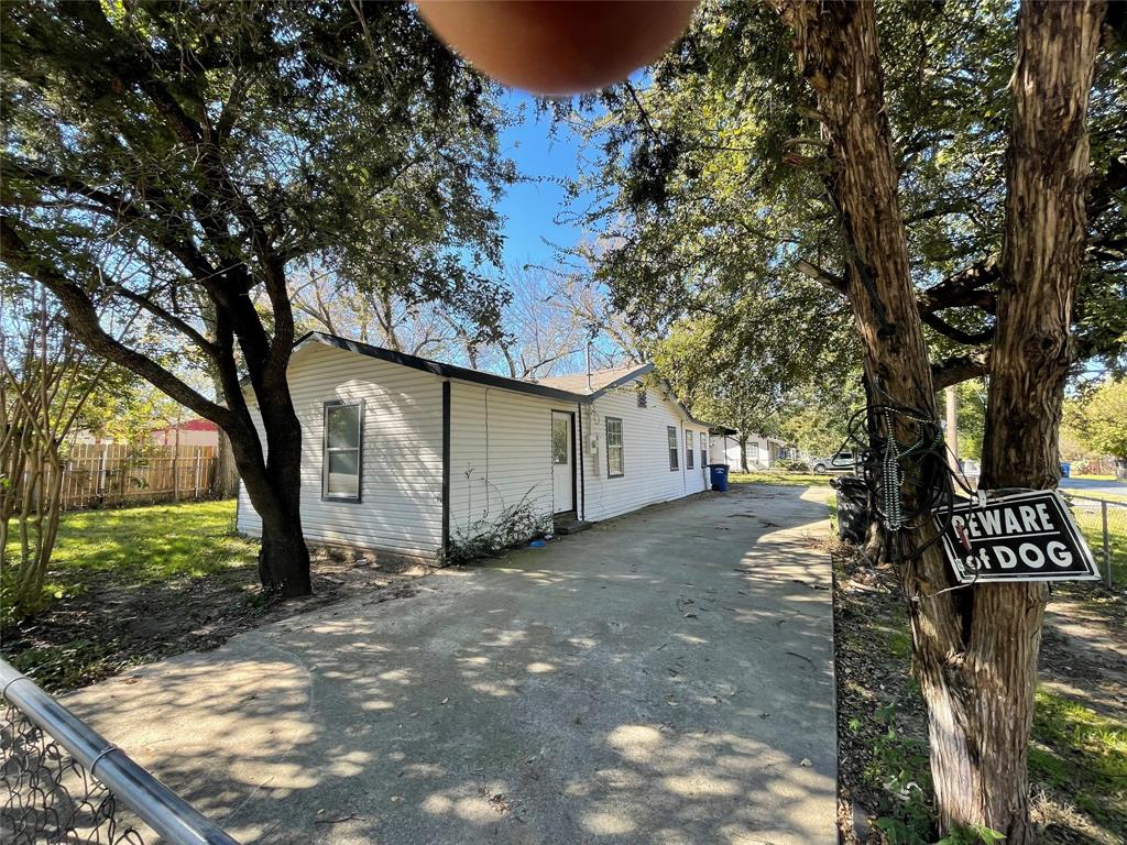 1041 Bradfield Road Dallas, TX 75217 - Photo 2 of 9 a view of a yard with plants and trees