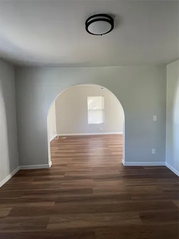 a view of a room with wooden floor