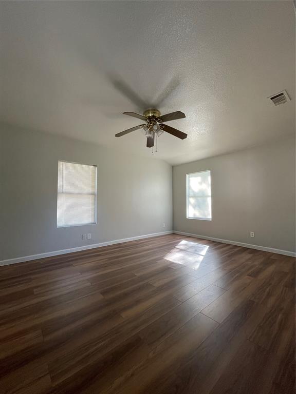 1041 Bradfield Road Dallas, TX 75217 - Photo 9 of 9 a view of empty room with wooden floor and fan