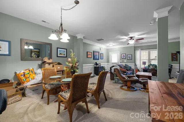 a living room with lots of furniture and a chandelier