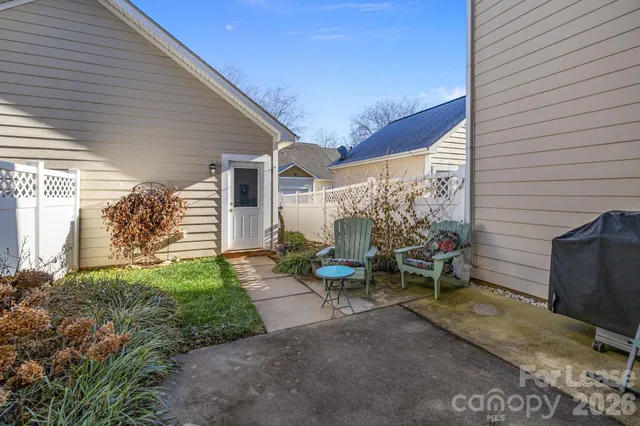 a view of a patio with table and chairs and potted plants