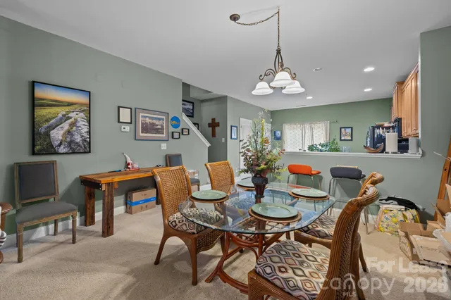 a view of a dining room with furniture and chandelier