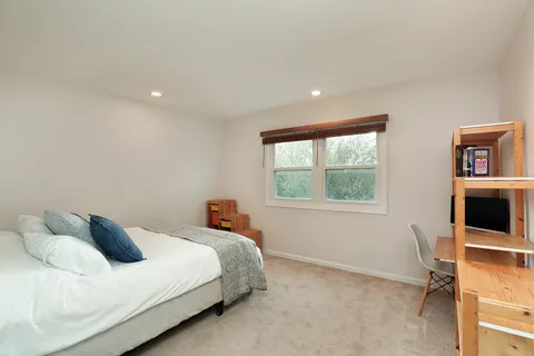 a bed room with a bed and a window