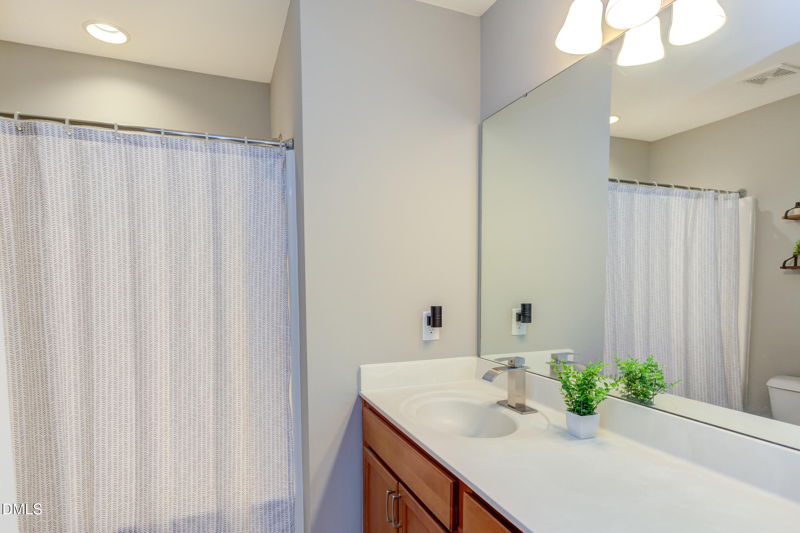 1434 Chatuga Way Wake Forest, NC 27587 - Photo 14 of 29 a bathroom with a sink and a mirror