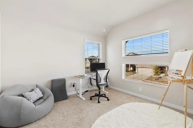 a view of a livingroom with workspace and a couch