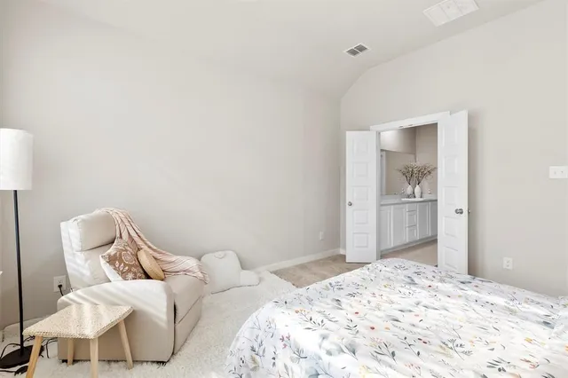 a bedroom with a bed and a chair