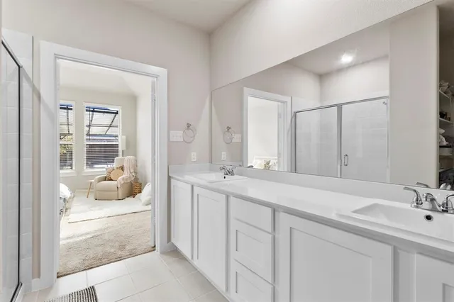 a en suite bathroom with double sink and a mirror