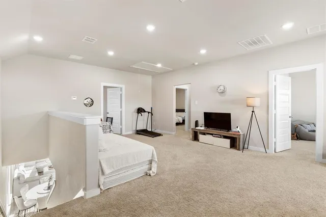 a bedroom with furniture and a flat screen tv