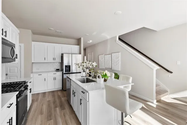 a kitchen with stove cabinets and wooden floor