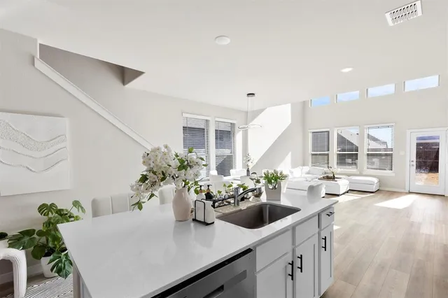 a dining room with furniture and potted plants