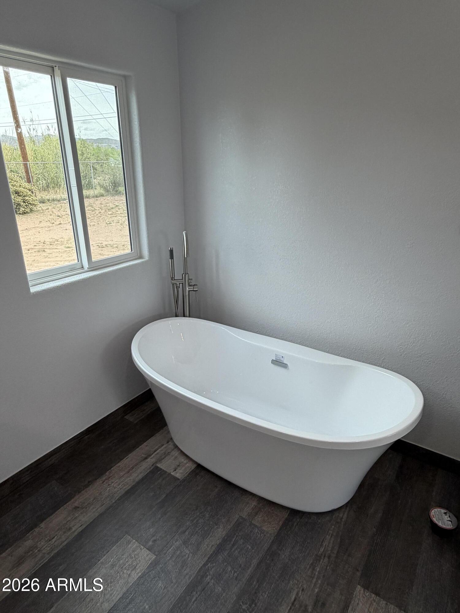 928 West Austin Street Bisbee, AZ 85603 - Photo 14 of 27 a white bath tub sitting in a bathroom