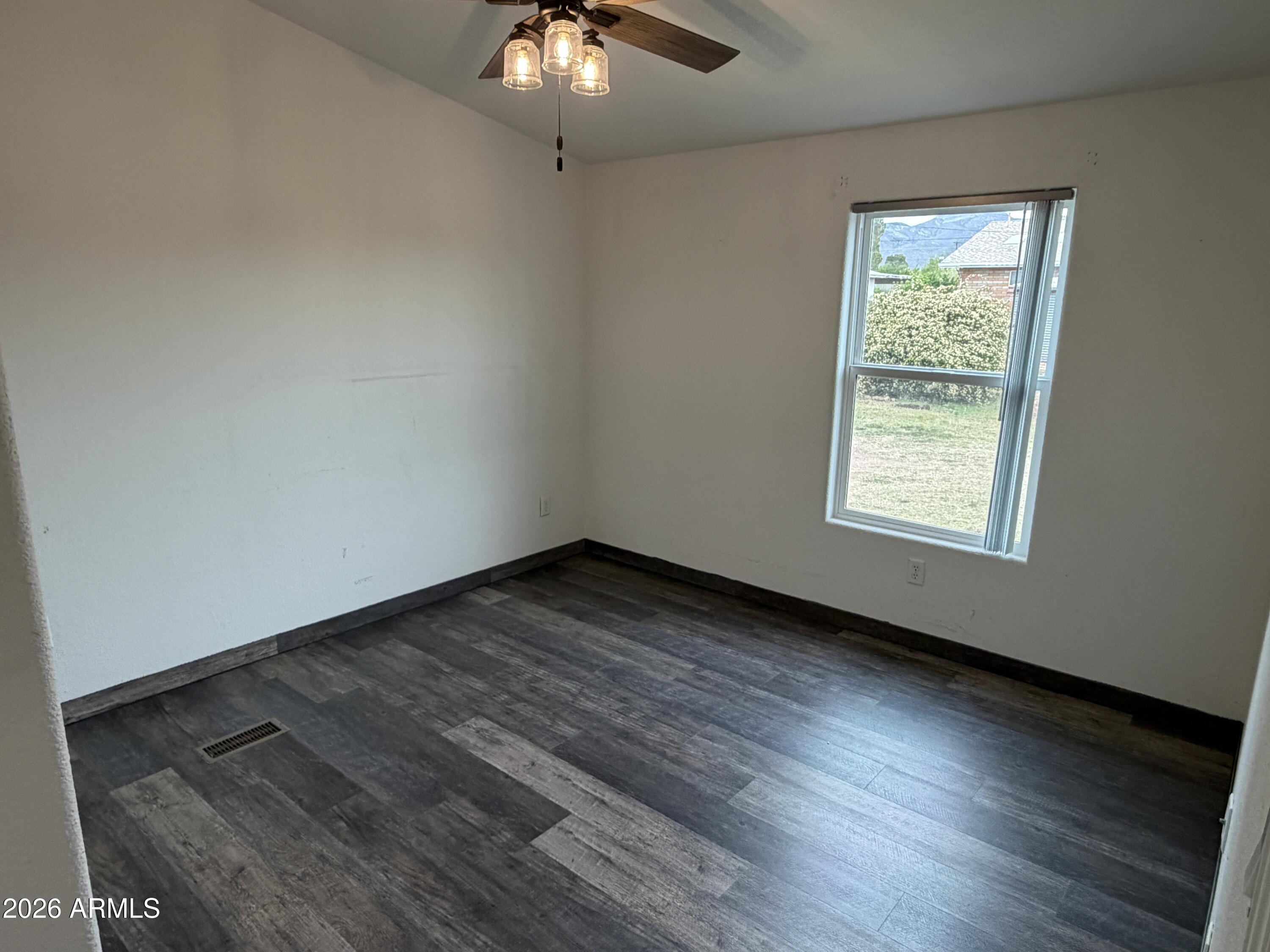 928 West Austin Street Bisbee, AZ 85603 - Photo 20 of 27 an empty room with wooden floor and windows