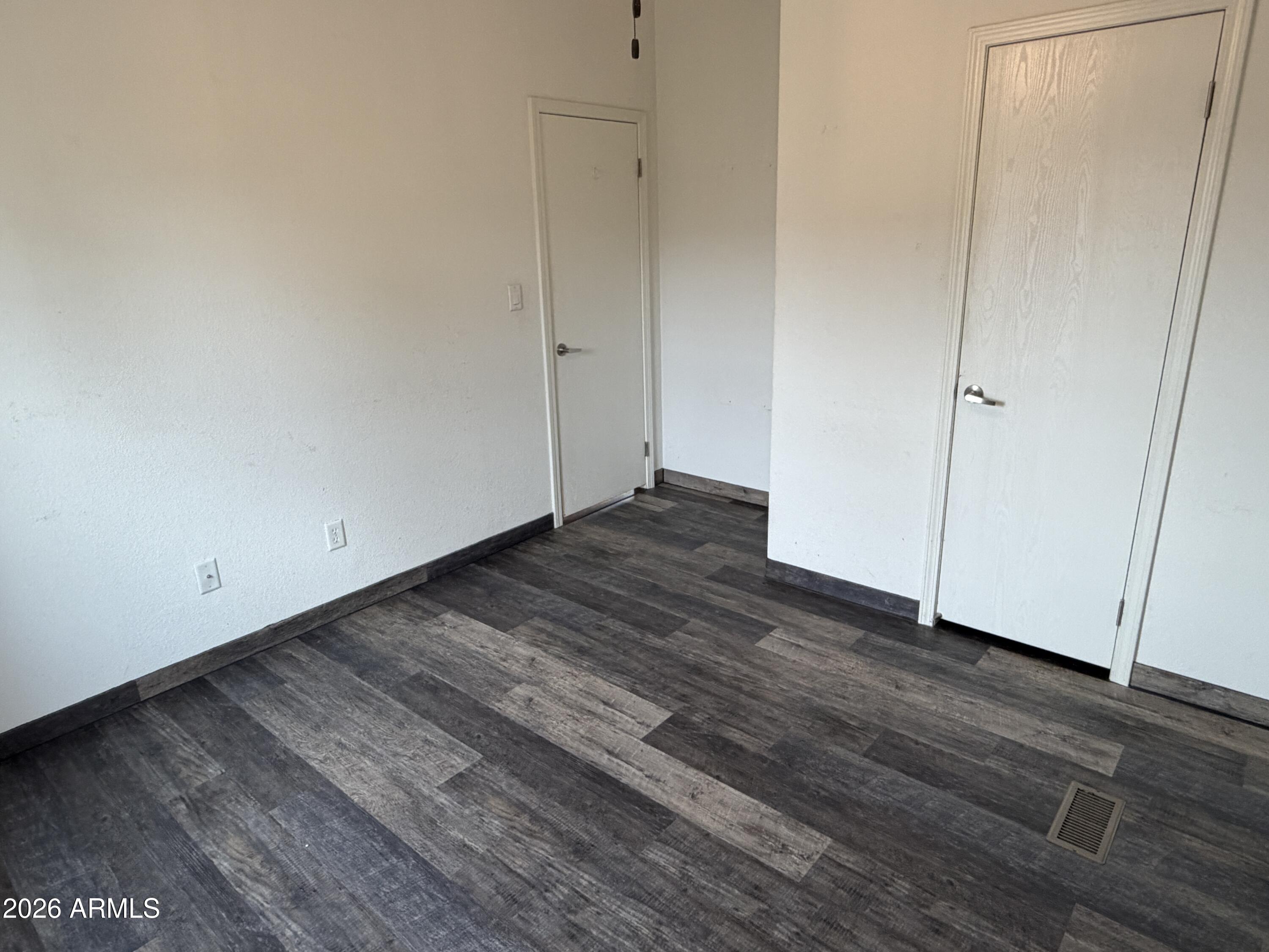 928 West Austin Street Bisbee, AZ 85603 - Photo 21 of 27 a view of an empty room with wooden floor