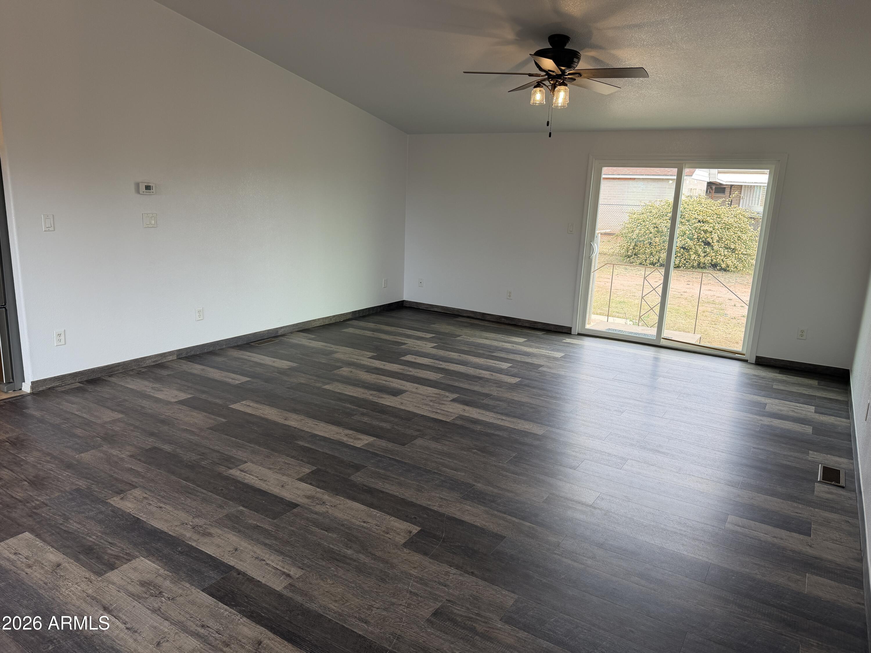 928 West Austin Street Bisbee, AZ 85603 - Photo 4 of 27 wooden floor in an empty room with a window