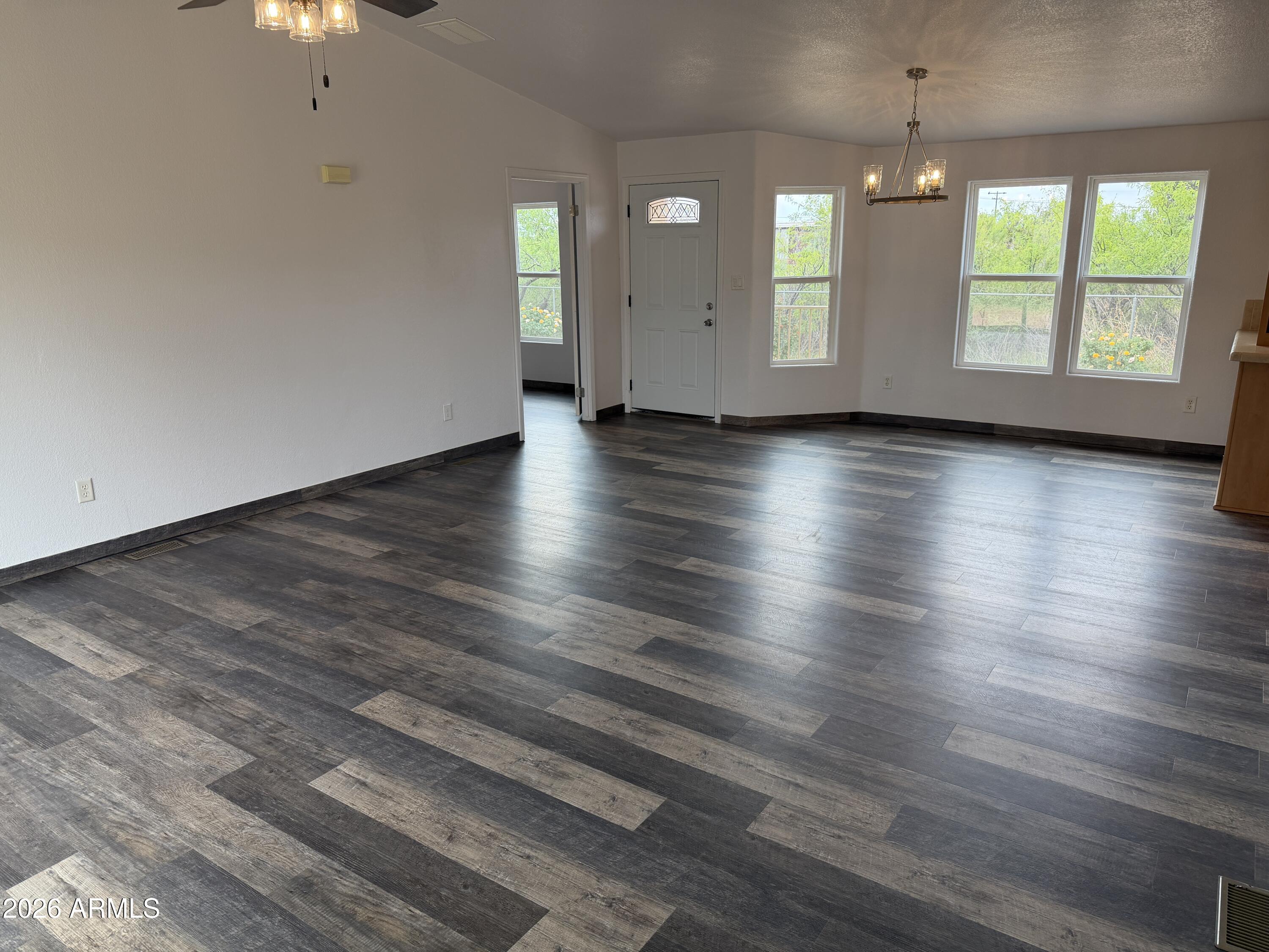 928 West Austin Street Bisbee, AZ 85603 - Photo 5 of 27 an empty room with wooden floor and windows