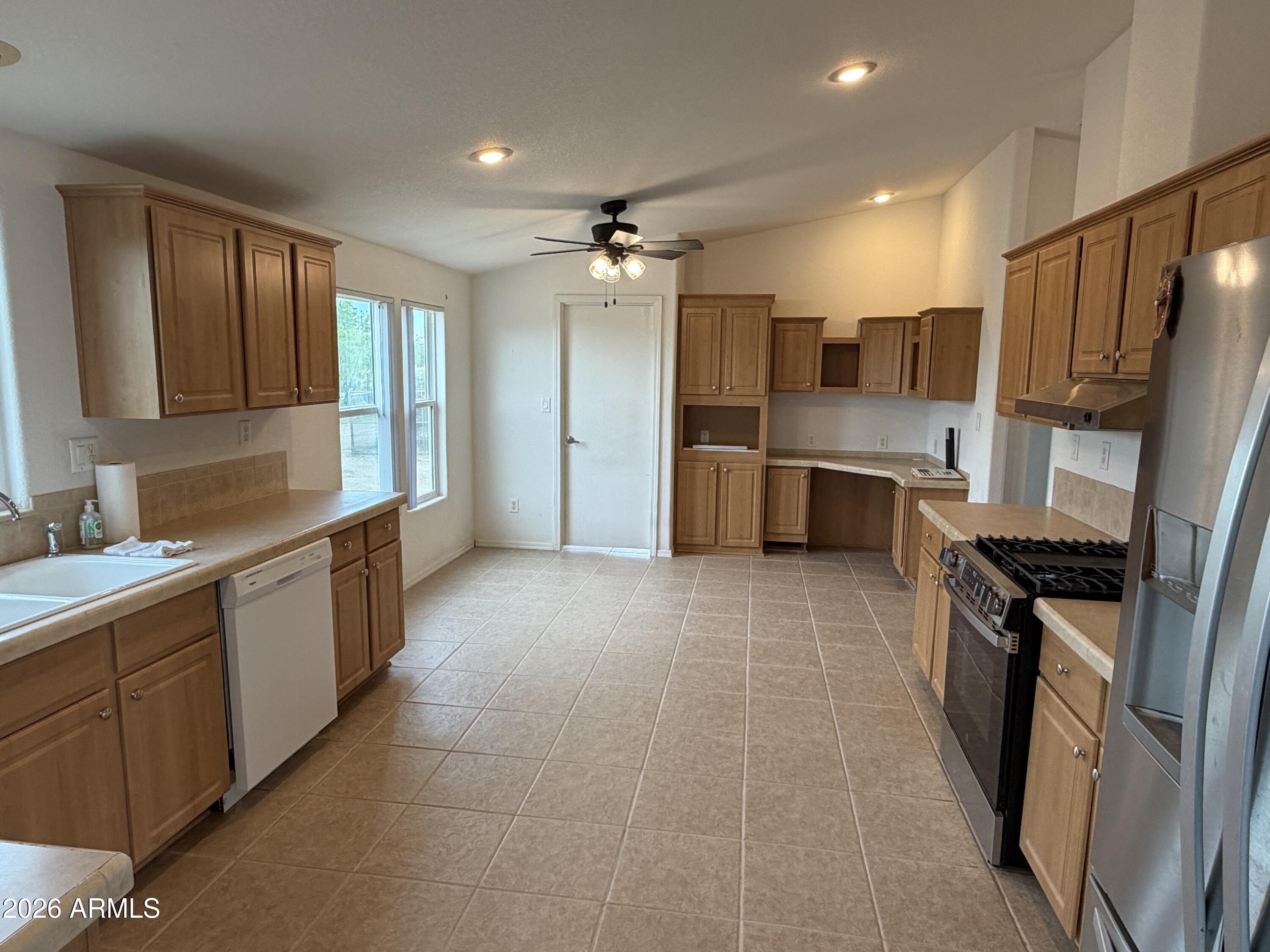 928 West Austin Street Bisbee, AZ 85603 - Photo 6 of 27 a large kitchen with a large counter top space a sink stainless steel appliances and cabinets