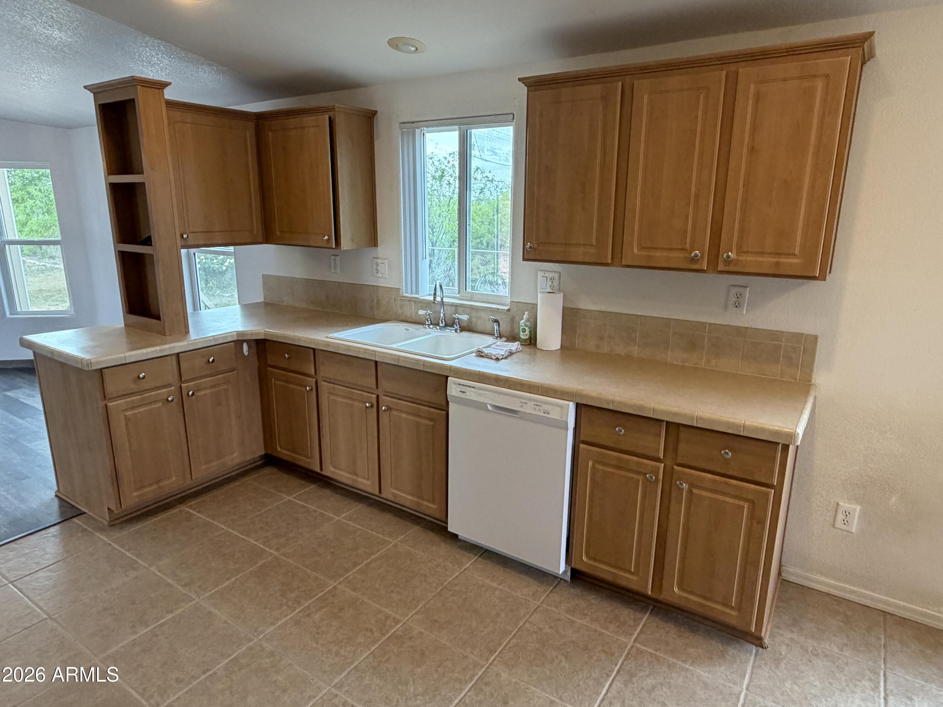 928 West Austin Street Bisbee, AZ 85603 - Photo 7 of 27 a kitchen with a sink window and cabinets
