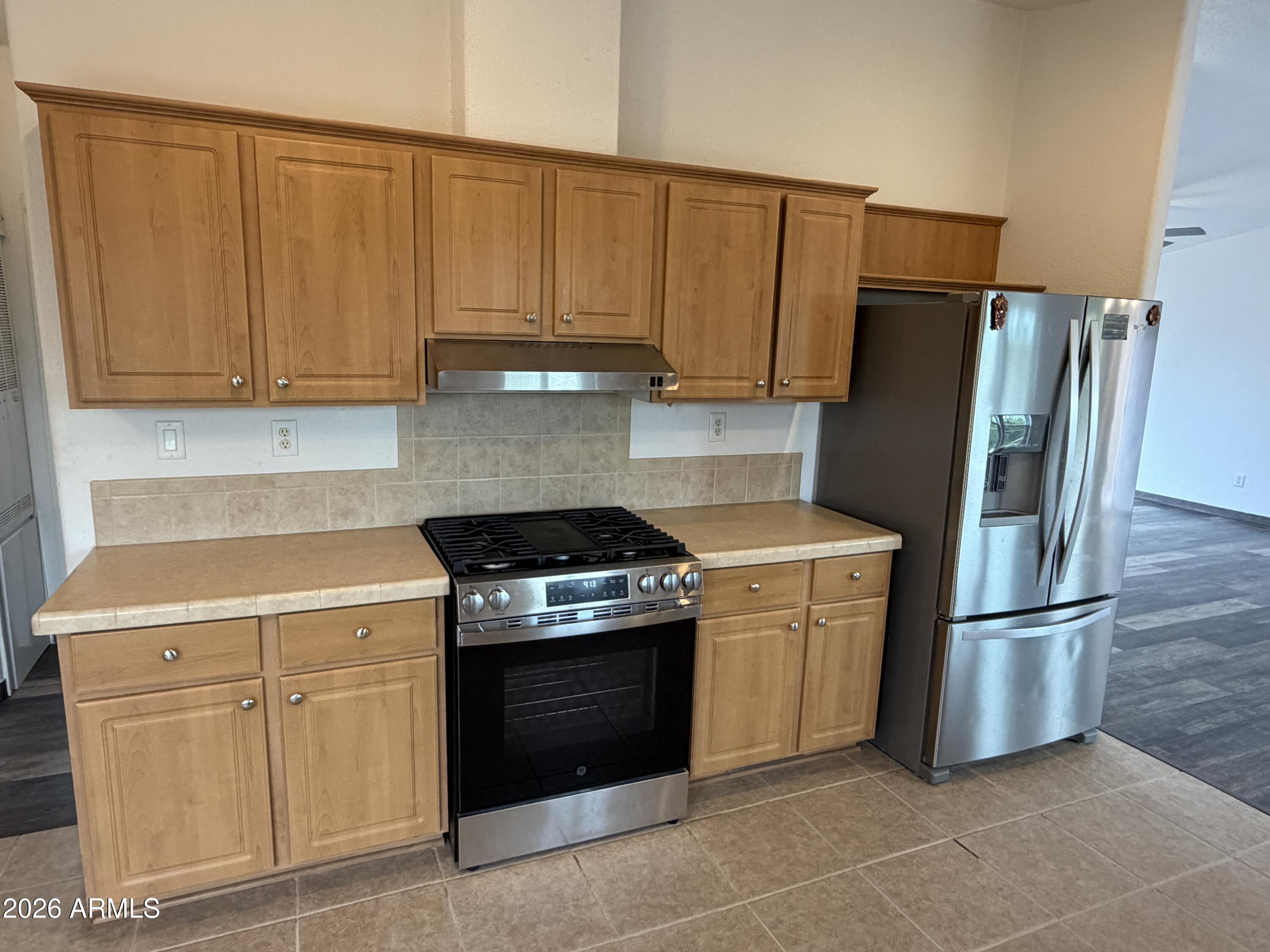 928 West Austin Street Bisbee, AZ 85603 - Photo 8 of 27 a kitchen with cabinets and stainless steel appliances