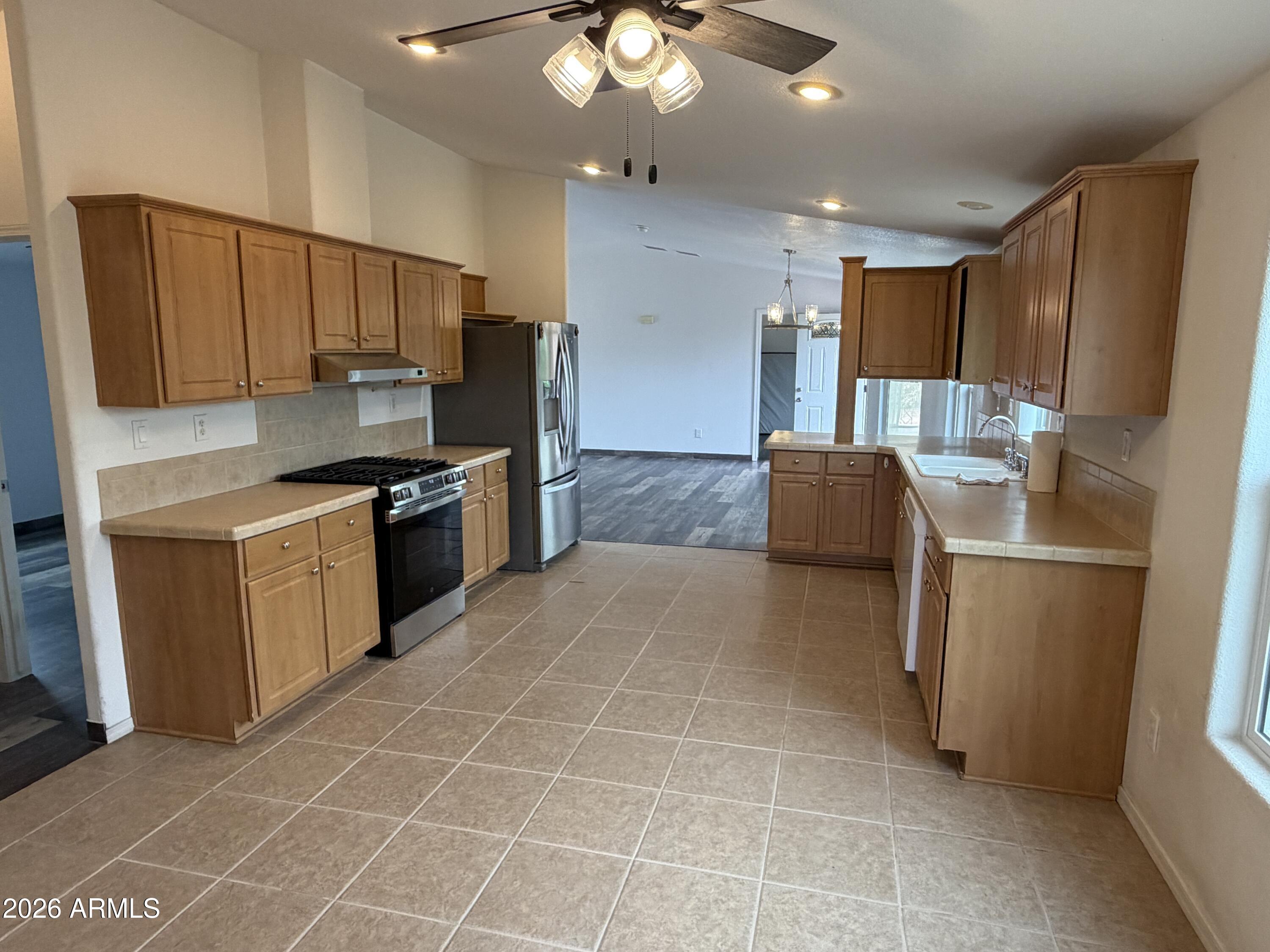 928 West Austin Street Bisbee, AZ 85603 - Photo 10 of 27 a kitchen with stainless steel appliances a refrigerator sink and microwave