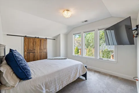 a bedroom with a bed and a lamp on table