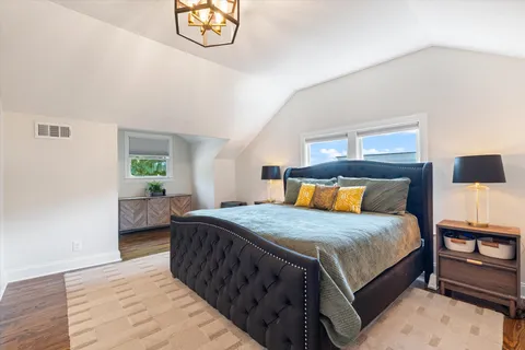 a living room with furniture a flat screen tv and a large window